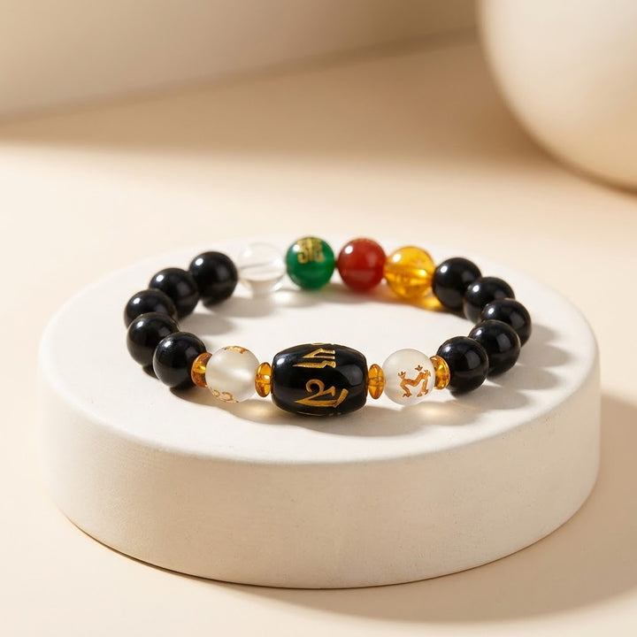 Black beaded bracelet with colorful beads on a white base