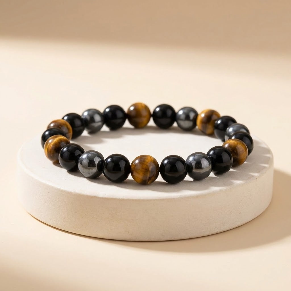 Beaded bracelet with black, brown, and gray stones on a beige background