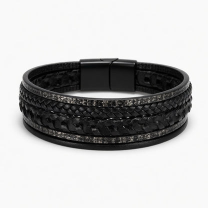 Multi-layer black men's bracelet featuring braided leather and textured industrial steel strands with a matte black magnetic clasp.