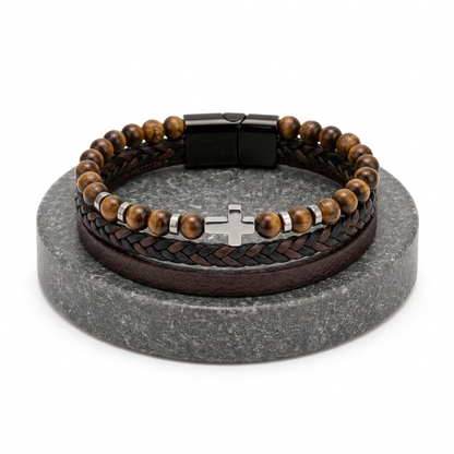 Bracelet with wooden beads and braided leather strap on a gray stand