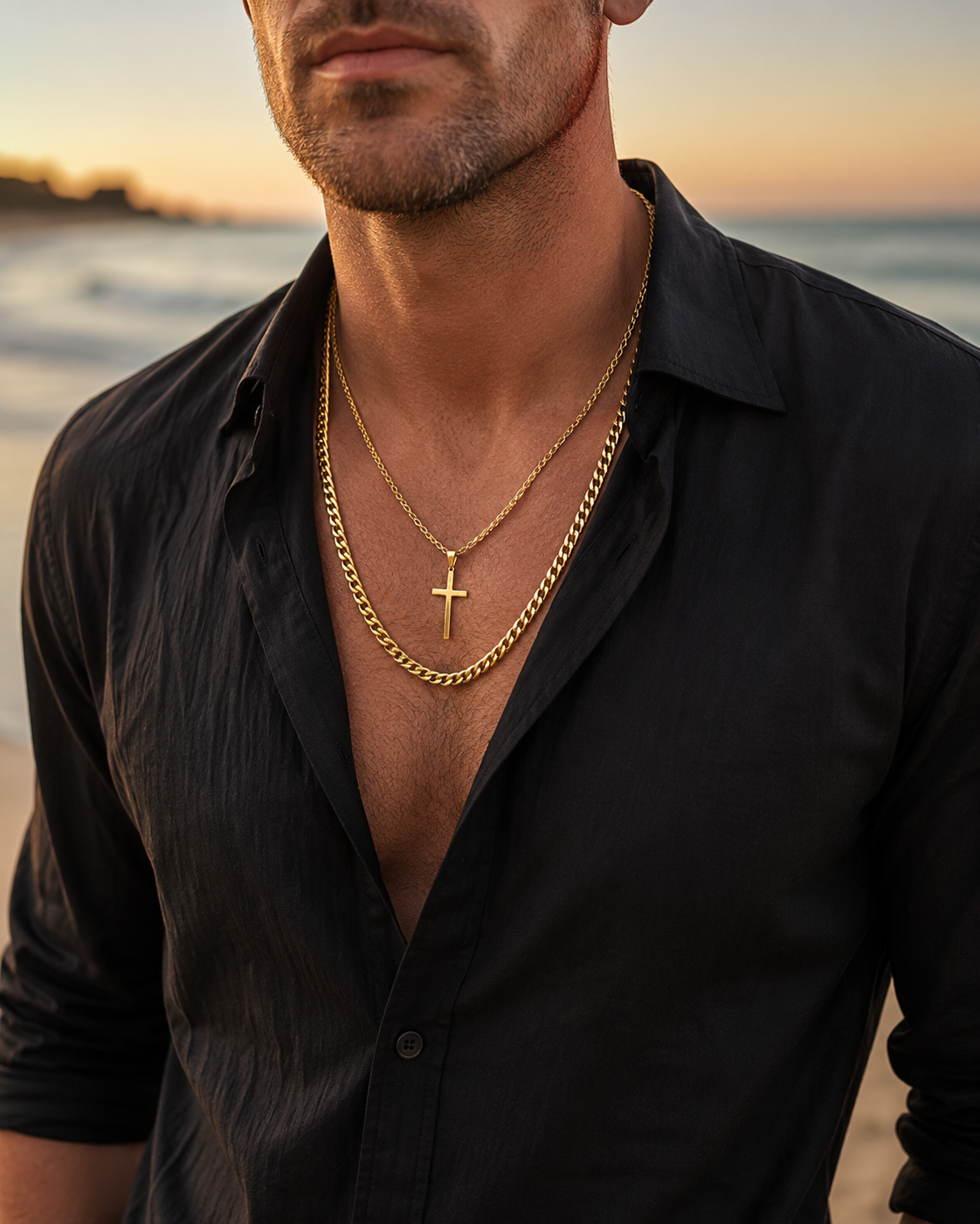 Premium gold cross pendant and curb chain layered necklace, isolated on a clean white background.