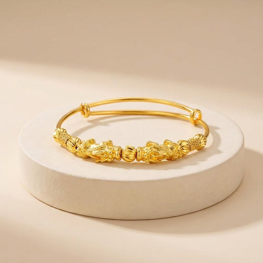 Gold bracelet on a beige background